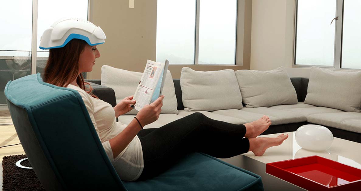 Woman reading while wearing a LLLT device.