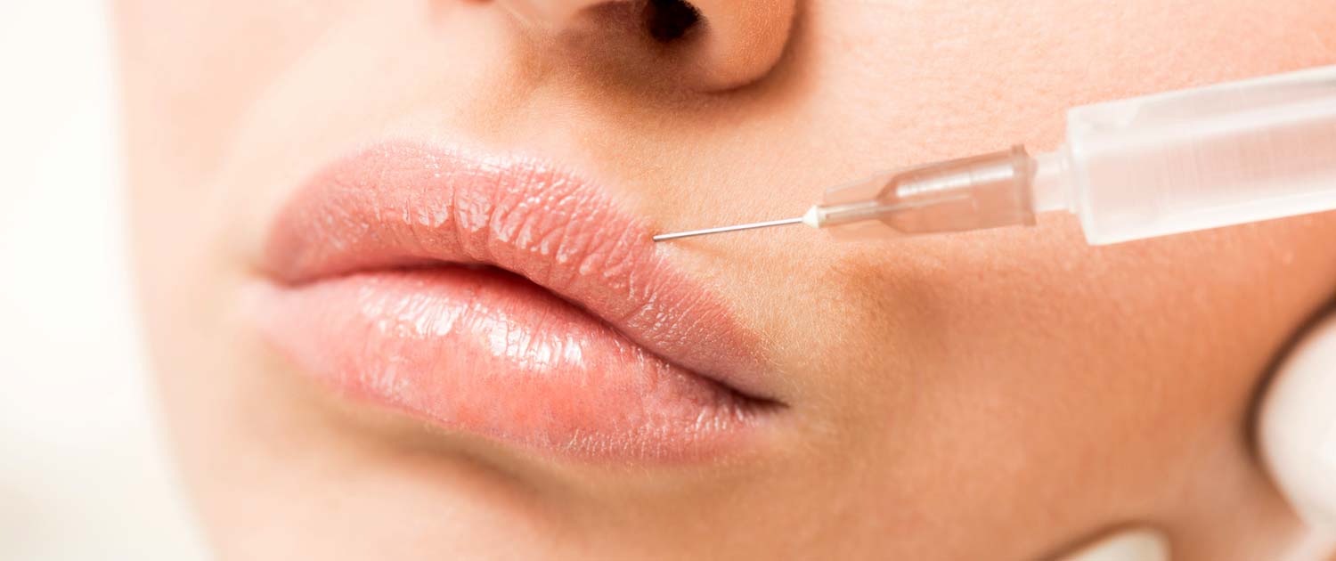 Woman getting filler injections in her lips