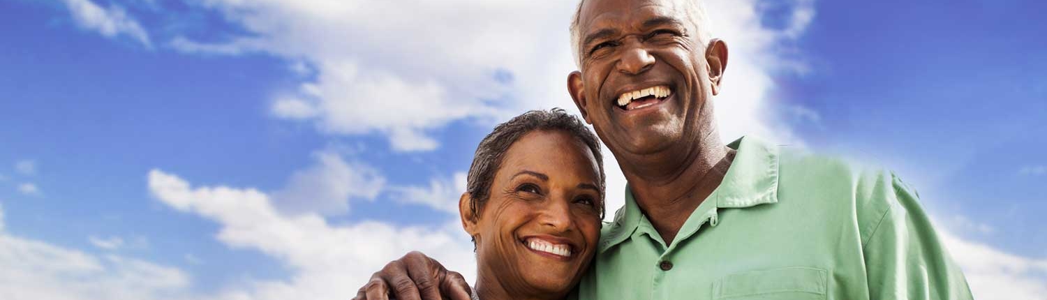 Happy mature couple under a beautiful blue sky.